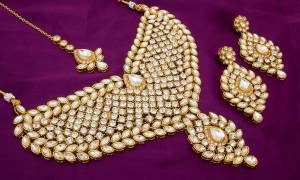 Here Is Heavy Bridal Necklace Set In Golden Color Beautified With Kundan Stone All Over It. This Heavy Necklace Set Can Be Paired With Any Colored Lehenga And It Will Definitely Earn You Lots Of Compliments From Onlookers. Buy Now.