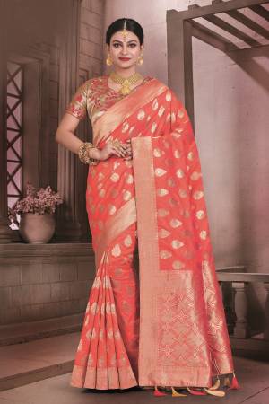 Orange Color Induces Perfect Summery Appeal To Any Outfit, So Grab this Beautiful Saree In Orange Color Paired With Golden Colored Blouse. This Saree And Blouse Are Fabricated On Art Silk Beutified with Weave. Buy It Now.