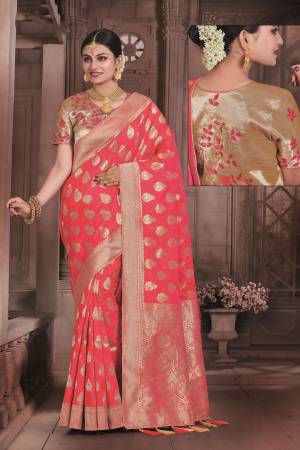 Shine Bright Wearing This Saree In Dark Peach Color Paired With Golden Colored Blouse. This Saree And Blouse Are Fabricated On Art Silk Beautified With Weave All Over It. This Rich Looking Saree Is Suitable For All Occasion.