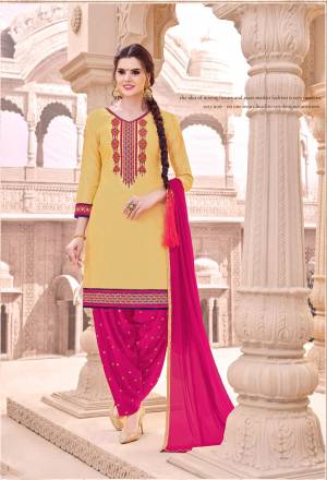 Here Is A Very Pretty And Attractive Dress Material In Yellow Colored Top Paired With Contrasting Dark Pink Colored Bottom And Dupatta. Its Top And Bottom Are Fabricated On Cotton Paired With Chiffon Dupatta. Its Top And Bottom Are Beautified With Thread Embroidery. Buy Now.
