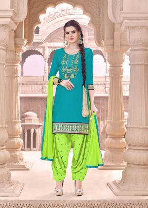 Celebrate This Festive Season Wearing This Beautiful Suit In Turquoise Blue Colored Top Paired With Contrasting Green Colored Bottom And Dupatta. Its Top And Bottom Are Fabricated On Cotton Paired With Chiffon Dupatta. Get This Dress Material Stitched As Per Your Desired Fit And Comfort.
