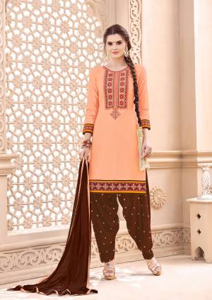 Add This Lovely Suit To Your Wardrobe In Peach Color Paired With Contrasting Brown Colored Bottom And Dupatta. Its Top And Bottom Are Fabricated On Cotton Paired With Chiffon Dupatta. Get This Dress Material Stitched As Per Your Desired Fit And Comfort. 