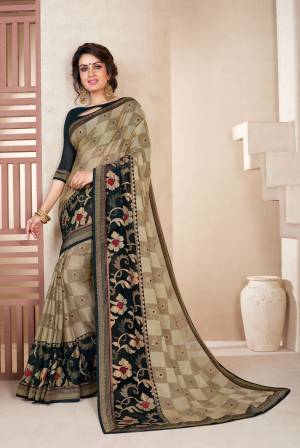 For A Bold And Beautiful Look, Grab This Saree In Beige Color Paired With Black Colored Blouse. This Saree Is Fabricated On Chiffon Brasso Paired With Art Silk Fabricated Blouse. It Is Beautified With Bold Checks And Floral Prints. 