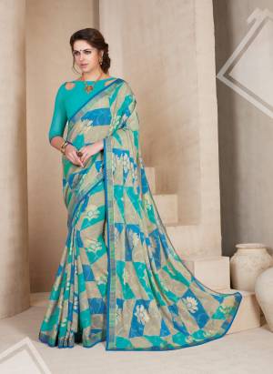 Summer Is About Cool And Subtle Shades To Beat The Heat. So Grab This Saree In Blue and Grey Color Paired With Blue Colored Blouse. This Saree Is Fabricated On Chiffon Brasso Paired With Art Silk Fabricated Blouse. Buy This Pretty Saree Now.