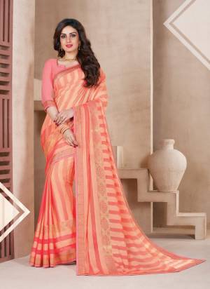 A Must Have Shade In Every Womens Wardrobe Is Here With This Saree In Peach Color Paired With Peach Colored Blouse. This Saree Is Fabricated On Chiffon Brasso Paired With Art Silk Fabricated Blouse.  It Is Light In Weight And Easy To Carry All Day Long.