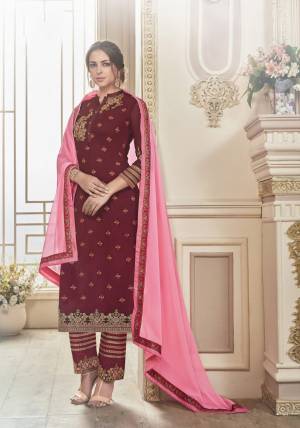 Look Beautiful And Attractive Wearing This Designer Straight Suit In Maroon Colored Top Paired With Maroon Colored Bottom And Contrasting Pink Colored Dupatta. Its Top Is Fabricated On Georgette Paired With Santoon Bottom And Chiffon Dupatta. It Is Beautified With Contrasting Embroidery Over The Top And Bottom. 