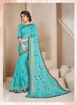 Here Is A Lovely Shade In Blue With This Saree In Turquoise Blue Color Paired With Turquoise Blue Colored Blouse. This Saree Is Fabricated On Chiffon Brasso Paired With Art Silk Fabricated Blouse. It Has Small Printed Motifs all Over The Saree.