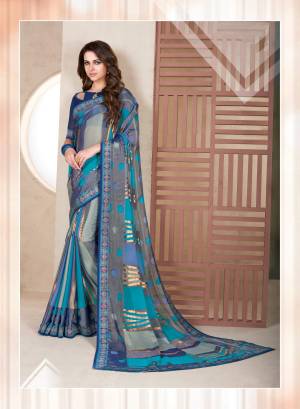 Grab This Saree With A Very Lovely Combination In Grey And Blue Color Paired With Navy  Blue Colored Blouse. This Saree Is Fabricated On Chiffon Brasso Paired With Art Silk Fabricated Blouse. This Saree Is Durable And Light In Weight To Carry All Day Long.