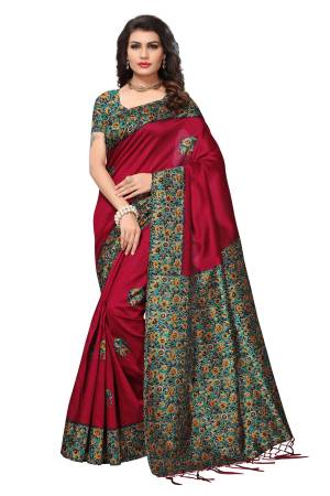 Give A Royal Look To Your Personality Wearing This Saree In Maroon Color Paired With Contrasting Green Colored Blouse. This Saree And Blouse Are Fabricated On Kashmiri Art Silk Beautified With Prints Over The Blouse And Pallu. Buy This Saree Now.