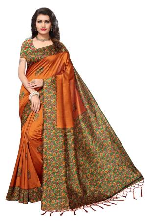 New And Unique Shade Is Here With This Saree In Rust Orange Color Paired With Contrasting Green Colored Blouse. This Saree And Blouse Are Fabricated On Kashmiri Art Silk Beautified With Prints And Tassels. 