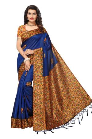 Shine Bright With This Royal Blue Colored Saree Paired With Contrasting Orange Colored Blouse. This Saree And Blouse Are Fabricated On Kashmiri Art Silk Beautified With Floral Prints And Tassels.