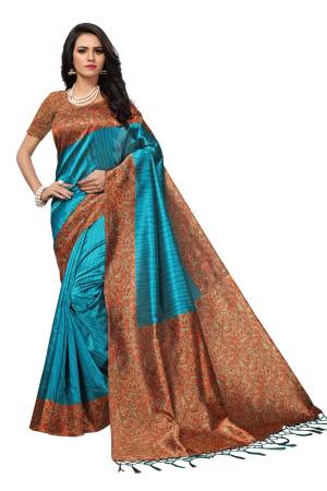 Add This Beauty To Your Wardrobe With This Saree In Blue Color Paired With Contrasting Orange Colored Blouse. This Saree And Blouse Are Fabricated On Kashmiri Art Silk Beautified With Prints Over The Blouse Are Saree Border.
