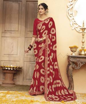 Grab This Beautiful Saree In Maroon Color Paired With Maroon Colored Blouse. This Saree And Blouse are Fabricated On Georgette Beautified With Bold Prints And Lace Border. Buy This Pretty Attractive Saree Now.