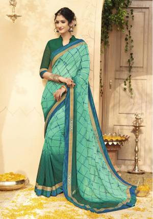 Add This Pretty Saree In shade Of Green With This Sea Green Colored Saree Paired With Green Colored Blouse. This Saree And Blouse are Fabricated On Georgette Beautified With Checks Prints All Over. 
