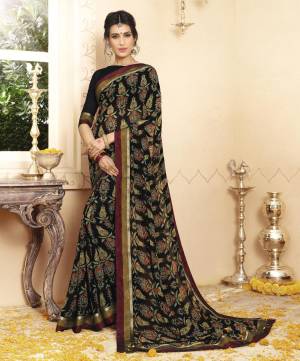 Bold And Beautiful Look Is Here with This Saree In Black Color Paired With Maroon Colored Blouse. This Saree And Blouse Are Fabricated On Georgette Beautified With Prints And Contrasting Lace Border. Buy This Saree Now.