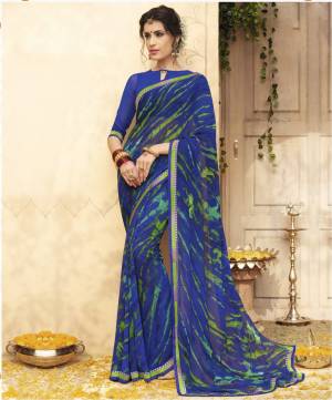 Shine Bright Wearing This Saree In Royal Blue Color Paired With Royal Blue Colored Blouse. This Saree And Blouse Are Fabricated On Georgette Beautified With Simple Prints. 