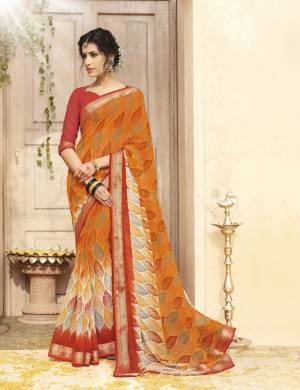 Orange Color Induces Perfect Summery Appeal To Any Outfit, So Grab This Saree In Orange Color Paired With Rust Orange Colored Blouse. This Saree And Blouse Are Fabricated On Georgette Beautified With Printed And Lace Border. Buy This Saree Now.