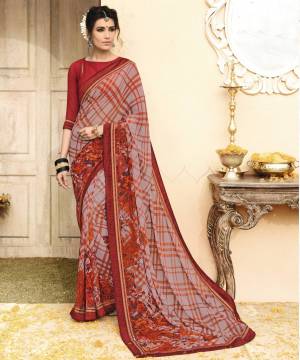 Add This New Shade To Your Wardrobe With This Saree In Mauve And Maroon Color Paired With Maroon Colored Blouse. This Saree And Blouse Are Fabricated On Georgette Beautified With Checks And Floral Prints. Buy This Saree Now.