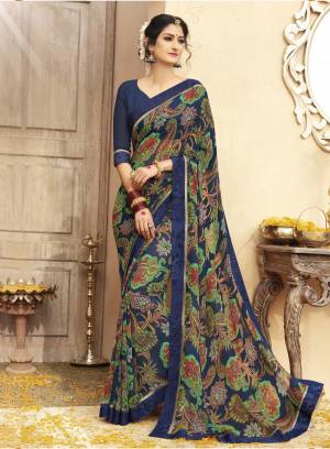 Enhance your Personality Wearing This Saree In Navy Blue Color Paired With Navy Blue Colored Blouse. This Saree And Blouse are Fabricated On Georgette Beautified With Bold Prints And Lace Border.  Grab It Now.