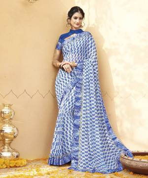 Pretty Simple And Elegant Looking Saree Is Here In White And Blue Color Paired With Blue Colored Blouse. This Saree And Blouse Are Fabricated On Georgette Beautified With Paisly Prints All Over It. Buy This Saree Now.