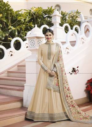 Flaunt Your Rich And Elegant Taste Wearing This Designer Floor Length Suit In Beige Colored Top Paired With Beige Colored Bottom And Grey Colored Dupatta. Its Top IS Fabricated On Art Paired With Santoon Bottom And Designer Net Fabricated Embroidered Dupatta. Buy Now