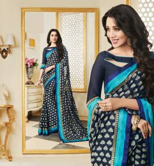 Enhance Your Personality Wearing This Saree In Navy Blue Color Paired With Navy Blue Colored Blouse, This Saree Is Fabricated On Silk Georgette Paired With Art Silk Fabricated Blouse. It Is Beautified With contrasting Floral Print All Over. 