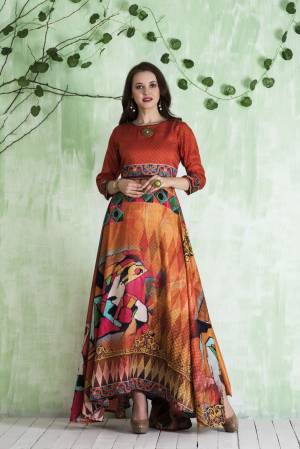 Shine Bright Wearing This Readymade Floor Length Gown In Orange And Multi Color Fabricated On Tussar Art Silk Beautified With Prints All Over. 