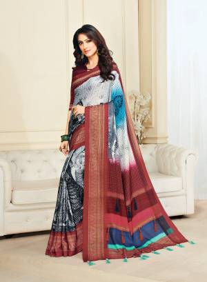 Add Ths Pretty Saree To Your Wardrobe In White And Maroon Color Paired With Maroon Colored Blouse. This Saree And Blouse Are Fabricated On Jute Silk Beautified With Multiple Tassels And Prints.