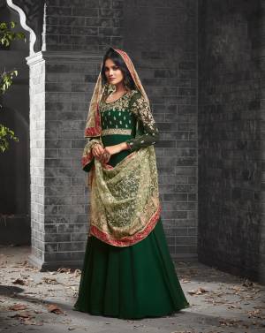 Dark Colors Always Give An Enhanced Look to Your Beauty, Grab This Designer Floor Length Suit In Pine Green Colored Top Paired With pne Green Colored Bottom And Light Green Colored Dupatta. Its Top Is Fabricated On Georgette Paired With Santoon Bottom And Net Fabricated Dupatta. Buy This Designer Suit Now.