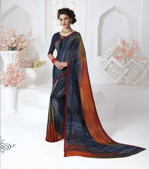 Enhance Your Personality Wearing This Saree In Navy Blue Color Paired With Navy Blue Color Paired With Navy Blue Colored Blouse. This Saree And Blouse Are Fabricated On Georgette. It Is Light Weight, Easy To Drape And Carry All Day Long.