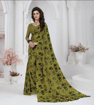 New And Unique Shade In Green Is Here With This Saree In Olive Green Color Paired With Olive Green Colored Blouse. This Saree And Blouse Are Fabricated On Georgette Small Prints ALL Over It. Buy Now.