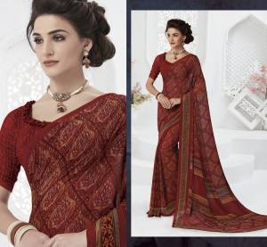 For A Royal Look, Grab This Dark Colored Saree In Maroon Paired With Maroon Colored Blouse, This Saree And Blouse Are Fabricated On Georgette Beautified With Prints. Buy This Saree Now.