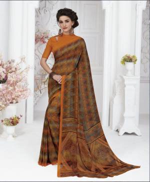 Add This New Shade In Orange To Your Wardrobe With This Saree In Rust Orange Color Paired With Orange Colored Blouse. This Saree And Blouse Are Fabricated On Georgette Beautified With Prints All Over.