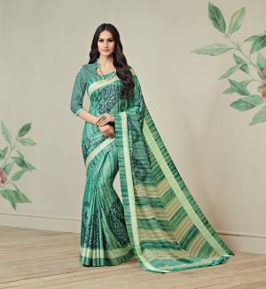 Add This Saree For Your Casual Wear In Green Color Paired With Green Colored Blouse, This Saree Is Fabricated On Jute Art Silk Paired With Art Silk Fabricated Blouse. It Is Light Weight And Easy To Drape. Buy This Saree Now.