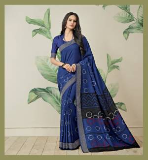 You Will Definitely Earn Lots Of Compliments Wearing This Printed Saree In Dark Blue color Paired With Dark Blue Colored Blouse. This Saree Is Fabricated On Jute Art Silk Paired With Art Silk Fabricated Blouse. Its Dark Color And Prints Make The Saree Attractive.