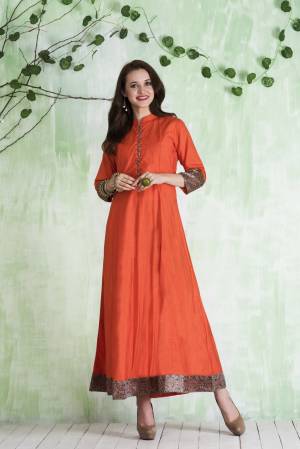 Grab This Simple and Attractive Readymade Kurti In Orange Color Fabricated On Cotton. This Pretty kurti Is Beautified With Prints And Buttons. This Can Be Paired With Orange Or Brown Colored Leggings. 