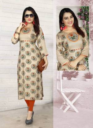 Grab This Simple Kurti In Beige Color For Your Semi-Casual Wear. This Readymade kurti Is Fabricated Rayon Beautified With Prints All Over It. 