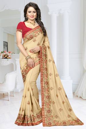 Simple And Elegant Looking Heavy Designer Saree Is Here In Beige Color Paired With Red Colored Blouse. This Saree Is Fabricated On Soft Silk Paired With Art Silk Fabricated Blouse. It Is Beautified With Heavy Embroidery Over The Saree Making It More Attractive.