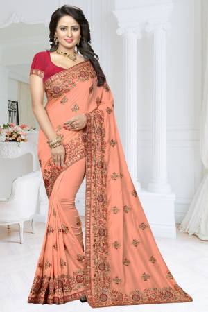 A Must Have Shade In Every Womnes Wardrobe Is Here With This Heavy Designer Saree In Peach Color Paired With Contrasting Dark Pink Colored Blouse. This Saree Is Fabricated On Soft Silk Paired With Art Silk Fabricated Blouse. Buy This Saree Now.