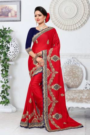 Adorn The Angelic Look Wearing This Attractive Saree In Red Color Paired With Contrasting Navy Blue Colored Blouse. This Saree Is Fabricated On Silk Paired With Art Silk Fabricated Blouse. It Has Heavy Jari Embroidery With Stone Work Making The Saree Attractive.