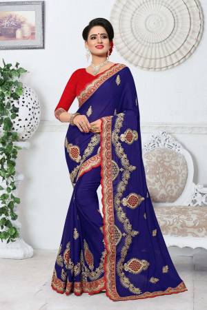 Attract All Wearing This Saree In Dark Blue Color Paired With Contrasting Red Colored Blouse. This Saree Is Fabricated On Silk Paired With Art Silk Fabricated Blouse. This Saree Is Suitable For Festive Wear Or Any Social Function.