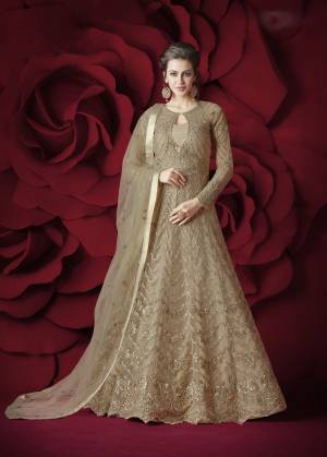 Simple And Elegant Looking Designer Floor Length Suit Is Here In Beige Color. Its Top Is Fabricated Net Beautified With Heavy Embroidery Paired With Silk Fabricated Bottom And Net Dupatta. This Suit Gives A Heavy Look But It Is Pretty Light Weight Which Ensures Superb Comfort All Day Long.