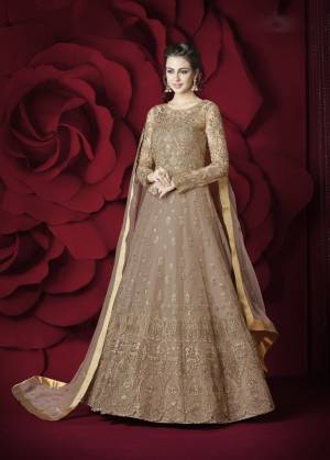 Simple And Elegant Looking Designer Floor Length Suit Is Here In Beige Color. Its Top Is Fabricated Net Beautified With Heavy Embroidery Paired With Silk Fabricated Bottom And Net Dupatta. This Suit Gives A Heavy Look But It Is Pretty Light Weight Which Ensures Superb Comfort All Day Long.