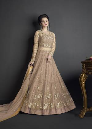 Flaunt Your Rich And Elegant Taste Wearing This Designer Suit In Beige Colored Top Paired With Beige Colored Bottom And Dupatta. Its Top Is Fabricated On Net Paired With Art Silk Fabricated Bottom And Net Fabricated Dupatta. Buy This Suit Now.It Is Beautiful Heavy Embroidery All Over Its Top Making The Suit More Attractive. 