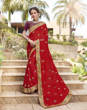Have A Glam And Attractive Look Wearing this Designer Saree In Red Color Paired With Blue And Red Colored Blouse. This Saree Is Fabricated On Georgette Paired With Jacquard Silk Fabricated Blouse. The Two Beautiful Attractive Combination Will Give You A Look Like Never Before.
