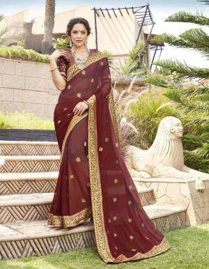 Add This Lovely Shade To Your Wardrobe With This Designer Saree In Wine Color Paired With Contrasting Brown Colored Blouse. This Saree Is Fabricated On Chiffon Paired With Jacquard Silk Fabricated Blouse. Buy This Saree Now.