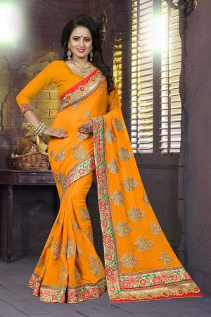 Celebrate This Festive Season Wearing This Designer Saree In Musturd Yellow Color Paired With Musturd Yellow Colored Blouse. This Saree And Blouse Are Fabricated On Georgette Beautified With Heavy Embroidery. 