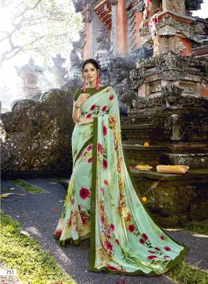 This Season Is About Subtle Shades And Pastel Play, So Grab This Saree In Pastel Green Color Paired With Olive Green Colored Blouse. This Saree Is Fabricated On Georgette Paired With Art Silk Fabricated Blouse. It Is Beautified With Contrasting Floral Prints And Stone Work Over The Border.