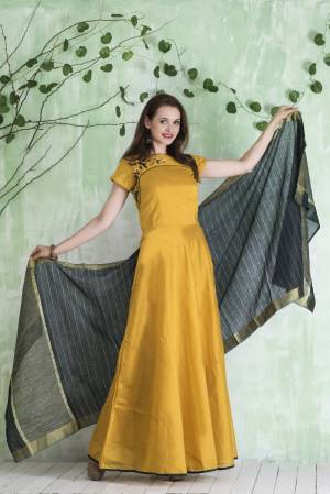 Celebrate This Festive Season Wearing This Designer Floor Length Suit In Yellow Colored Top Paired With Yellow Colored Leggings And Contrasting Grey Colored Dupatta. Its Top Is Fabricated On Chanderi Paired With Lycra Leggings And Viscose Jacquard Dupatta. It Is Beautified With Hand Work Over The Yoke. Buy Now.