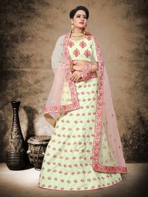 Very Elegant And Pretty Looking Designer Lehenga Choli Is Here In Cream Color Paired With Baby Pink Colored Dupatta. Its Blouse And Lehenga Are Fabricated On Satin Paired With Net Fabricated Dupatta. It Has Pretty Embroidered Motifs All Over It. 